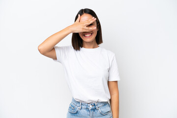 Young caucasian woman isolated on white background covering eyes by hands and smiling