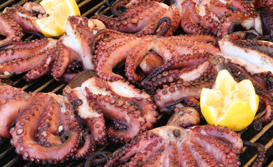 grilled octopus and lemon to garnish the fish dish in the restaurant specializing in seafood