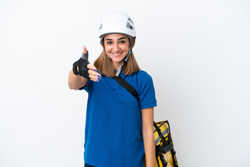 Young caucasian woman with thermal backpack isolated on white background shaking hands for closing a good deal