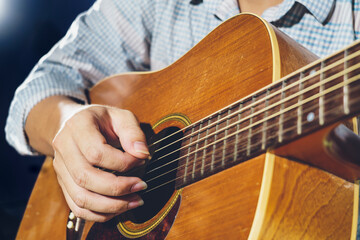 Closeup of hand playing  acoustic guitar
