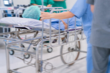 Motion blur of staff rushing patient to emergency room at hospital