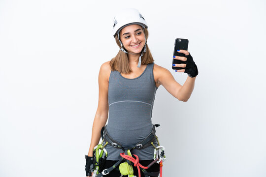 Young rock-climber woman isolated on white background making a selfie