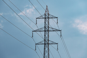 An electric pole with lines and cables for transmitting energy to consumers. Electrification and industry