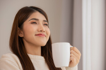 Asian woman take a cup of coffee and have a drink on a relaxing in morning