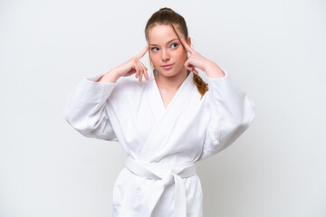 Young caucasian girl doing karate isolated on white background having doubts and thinking