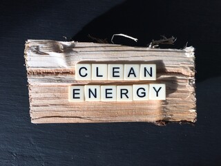 Words clean energy spelled out in letters on a piece of firewood