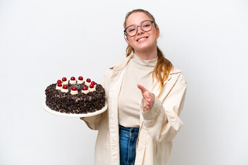 Young caucasian woman holding a Birthday cake isolated on white background shaking hands for closing a good deal