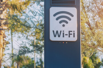 Wi-fi access point for wireless connection and digital communication in city park. Modern...