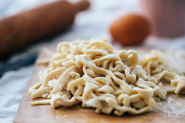 homemade noodles on a cutting board with flour