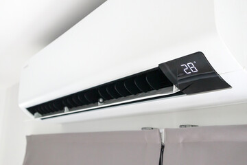 Air conditioner on white wall room interior background