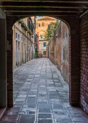 Passageway in Venice, Italy leading to a narrow street 