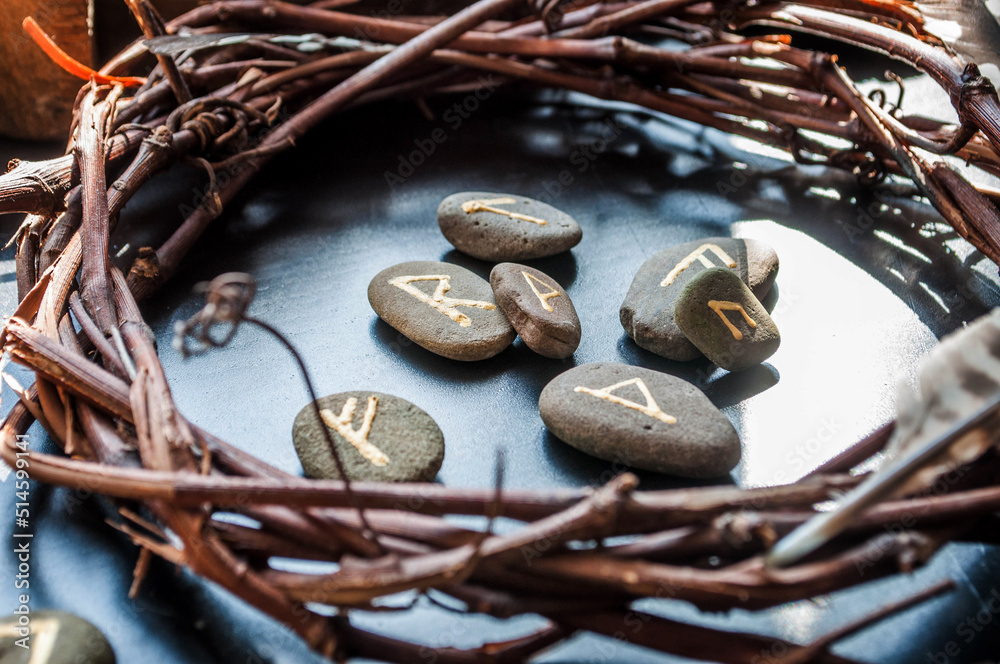 Wall mural rune stones on a wooden table. future reading concept.