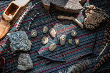 Rune stones on a wooden table. Future reading concept.