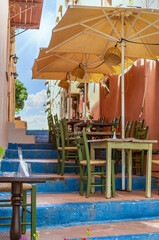Cozy outdoor cafe on the steps of the stairs in Rethymno, Crete, Greece.