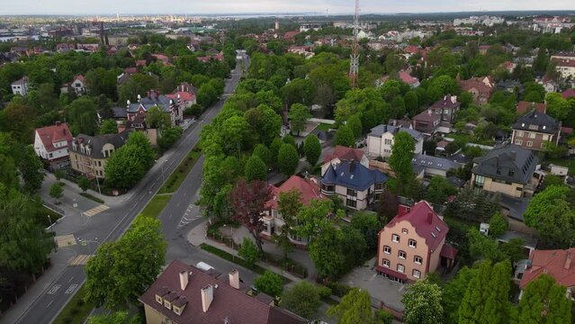 Aerial view of old town with buildings and trees and empty road in Amalienau district, Kaliningrad, Russia. 4k drone video