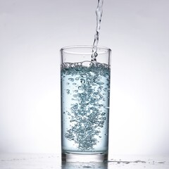 Image of pouring water from a water bottle into a glass