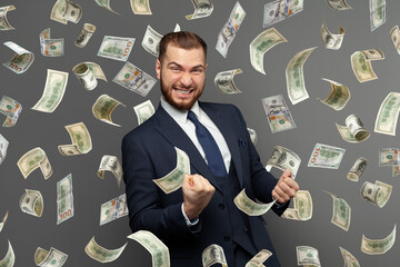 Businessman standing in the rain of money