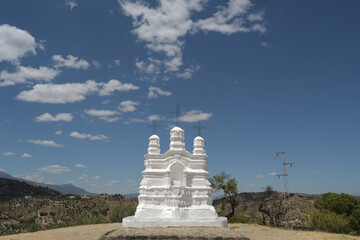 Religious monument a sunny day with clouds in the blue sky, Monda, Spain - obrazy, fototapety, plakaty