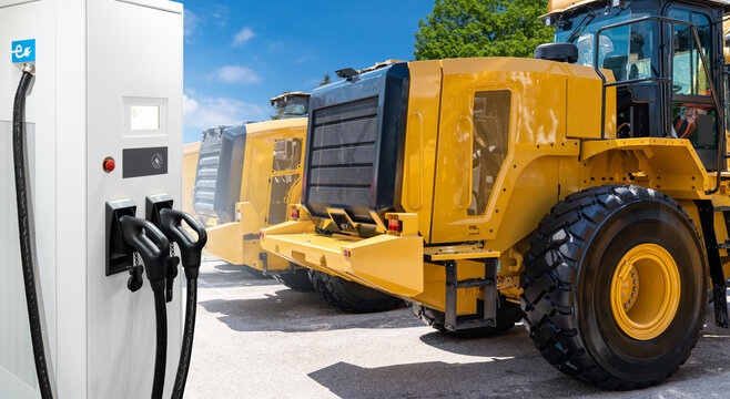 Electric Construction Machines With Charging Station. Concept