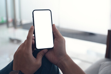 Mobile phone mockup for advertising. Mock up image of man hand holding and using smartphone with blank screen for mobile app design or text advertisement