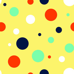 Seamless vector pattern with colourful dots on yellow background. Simple fun children wallpaper design. Decorative happy polka dots fashion textile.