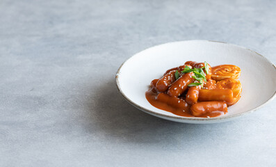 Tteokbokki, rice stick in spicy sauce, traditional korean cuisine, selective focus, copy space