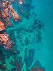Aerial view of the seascape of the rocks and the turquoise blue sea. Conceptual background of summer beach vacations.