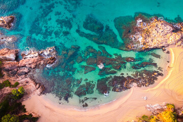 Aerial view of Sa Conca beach, Costa Brava, Catalunya, Mediterranean sea coast, Spain. Beach background with transparent turquoise blue water. Summer tourism. Beach vacations.