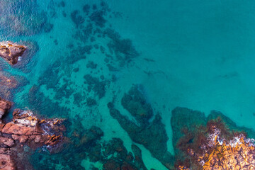 Aerial view of the seascape of the rocks and the turquoise blue sea. Conceptual background of summer beach vacations.