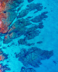 Aerial view over rocks landscape and blue turquoise sea at Costa Brava, Catalonia, Spain. Artistic summer background of the mediterranean coast. Summer conceptual background. Beach tourism vacations.