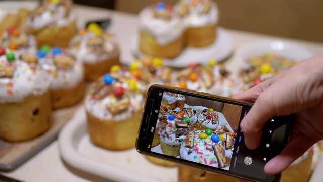 Female Hands Taking Pictures on Smartphone of Easter Cakes on the Table. Translation: video clip, video, photo, portrait, square. Blogger blogging about food, Easter. Orthodox religion event. 4K.