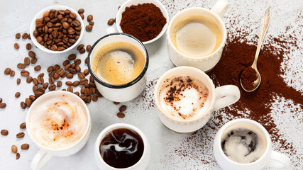 Coffee cup assortment on light background.