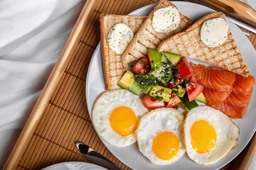 Fried toast with salmon slices, avocado, cucumbers, sesame seeds