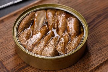 Delicious fresh sandwich with sprats with crispy toast, butter and cucumber