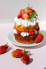 High mini cake with cream and strawberries.