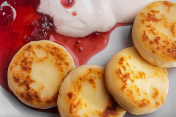 Pancakes in a plate with sour cream