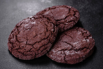 Delicious fresh chocolate biscuits on a dark concrete background with Christmas toys