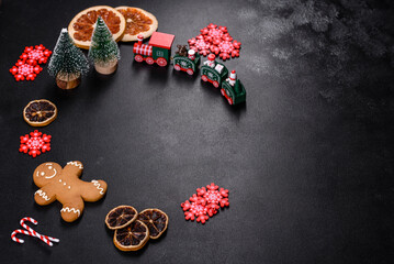 Delicious fresh chocolate biscuits on a dark concrete background with Christmas toys