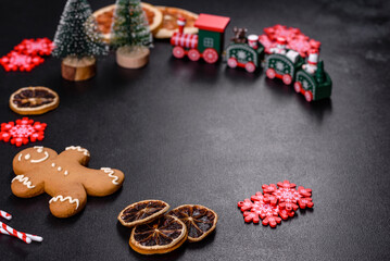 Delicious fresh chocolate biscuits on a dark concrete background with Christmas toys