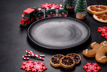 Delicious fresh chocolate biscuits on a dark concrete background with Christmas toys