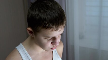 Portrait of Guilty, Talking Child, Looking Down at Floor with Downcast Eyes. Punishment. Guilt, remorse, conversation. Lowered gaze. Gesture. Depression. Behavior, emotion Transitional age Conflict