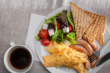 Fried toast with sausages, tomatoes, feta cheese, salad and omelet