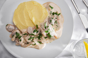 Mashed potatoes with mushrooms in sauce and parsley
