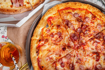Pizza with sausages, cheese, ketchup and bacon