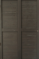 Closeup of wooden closet shutter doors. Minimal home interior design detail