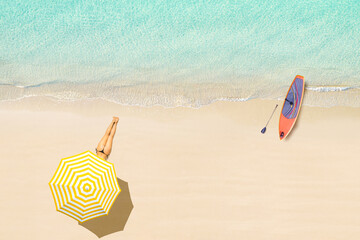 Top view of woman in bikini lying under umbrella and sunbathes on tropical Seychelles sea sand beach with SUP board for surfing. Aerial, drone view