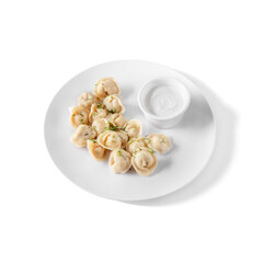 Dumplings with meat and dill in a plate with sour cream