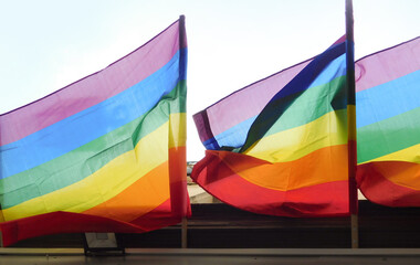 Pride rainbow lgbt gay flag being waved on sky background