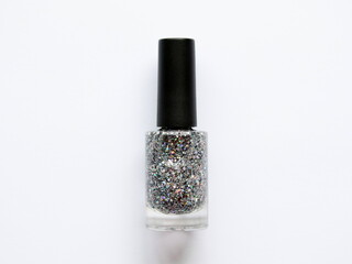 Glitter nail polish glass bottle isolated on white background, top view.