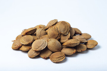 Apricot kernels on a white background. Dried apricot kernels